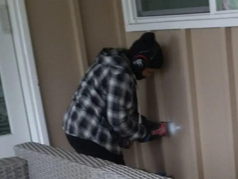 Professional electrician installing an exterior outlet in Carrollton